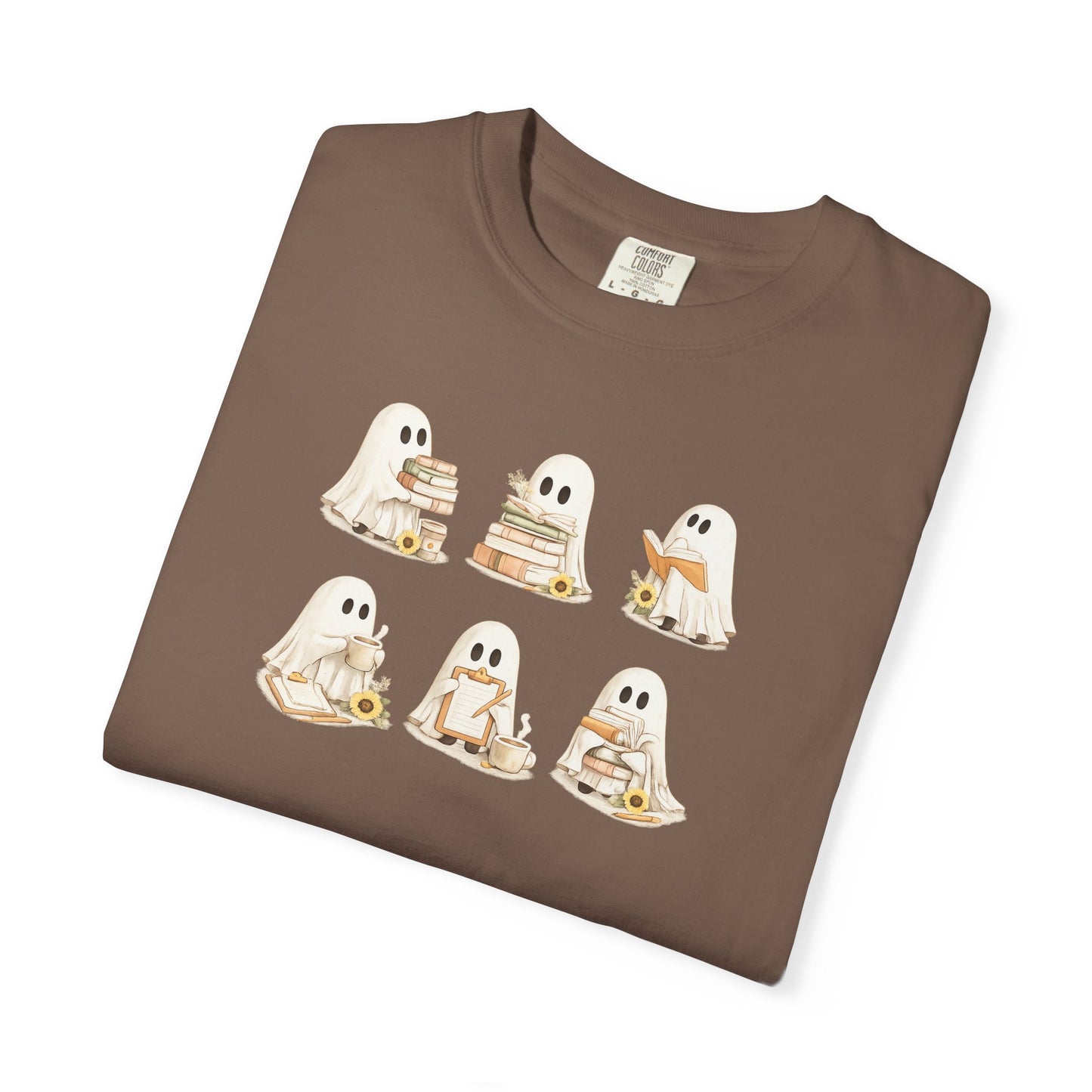 Brown Comfort Colors t-shirt folded flat lay with six hand-illustrated ghosts holding books design - Ghost Teacher Shirt by The Teechers Thread