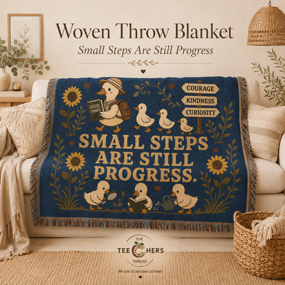 Navy woven throw blanket with duck and sunflower design draped over a cream sofa, Small Steps Are Still Progress - The Teechers Thread