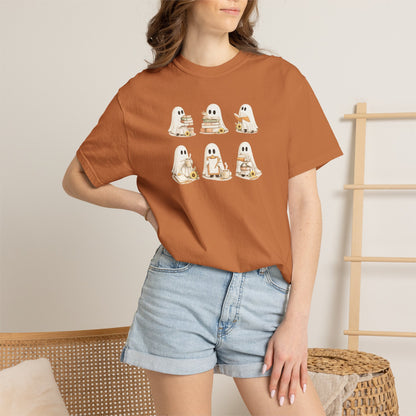 Woman wearing rust orange Comfort Colors Ghost Teacher Shirt with hand-illustrated ghosts holding books design - The Teechers Thread