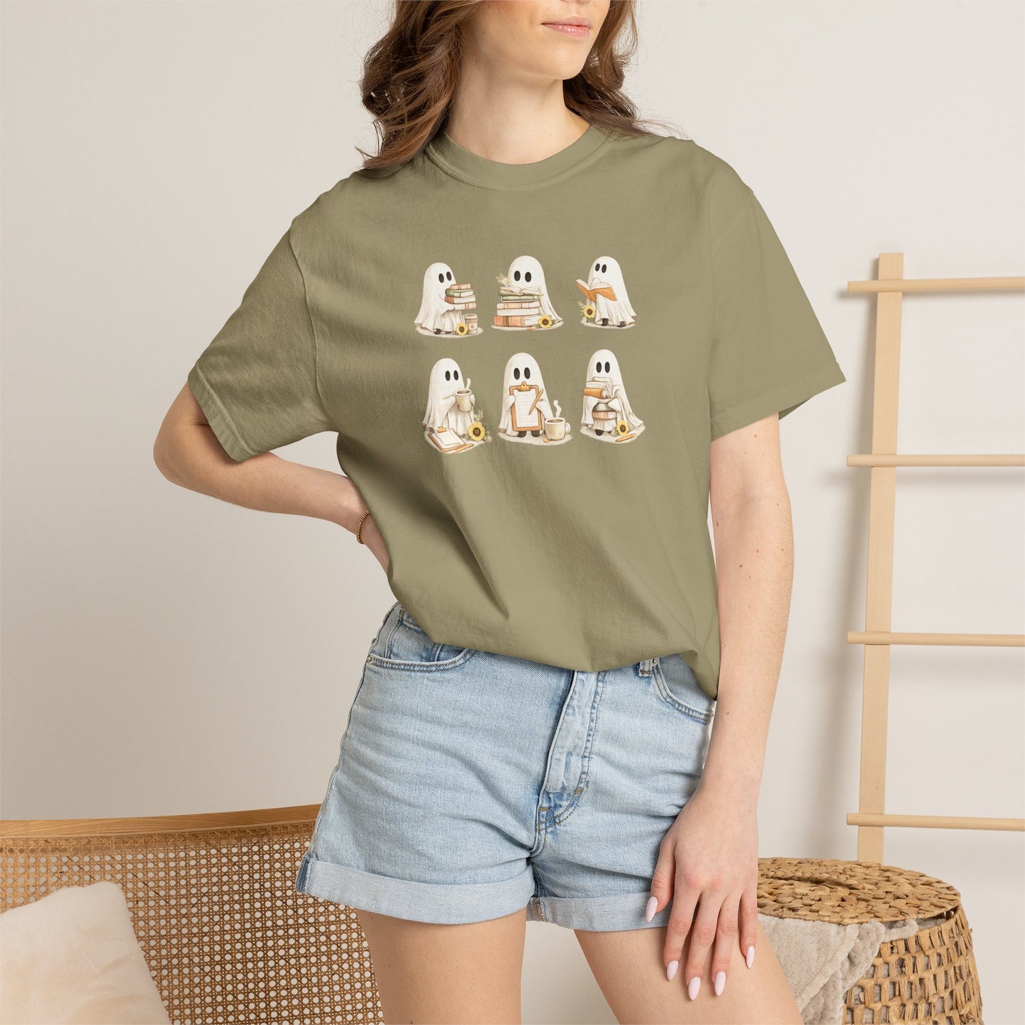 Woman wearing olive green Comfort Colors Ghost Teacher Shirt with hand-illustrated ghosts holding books design - The Teechers Thread