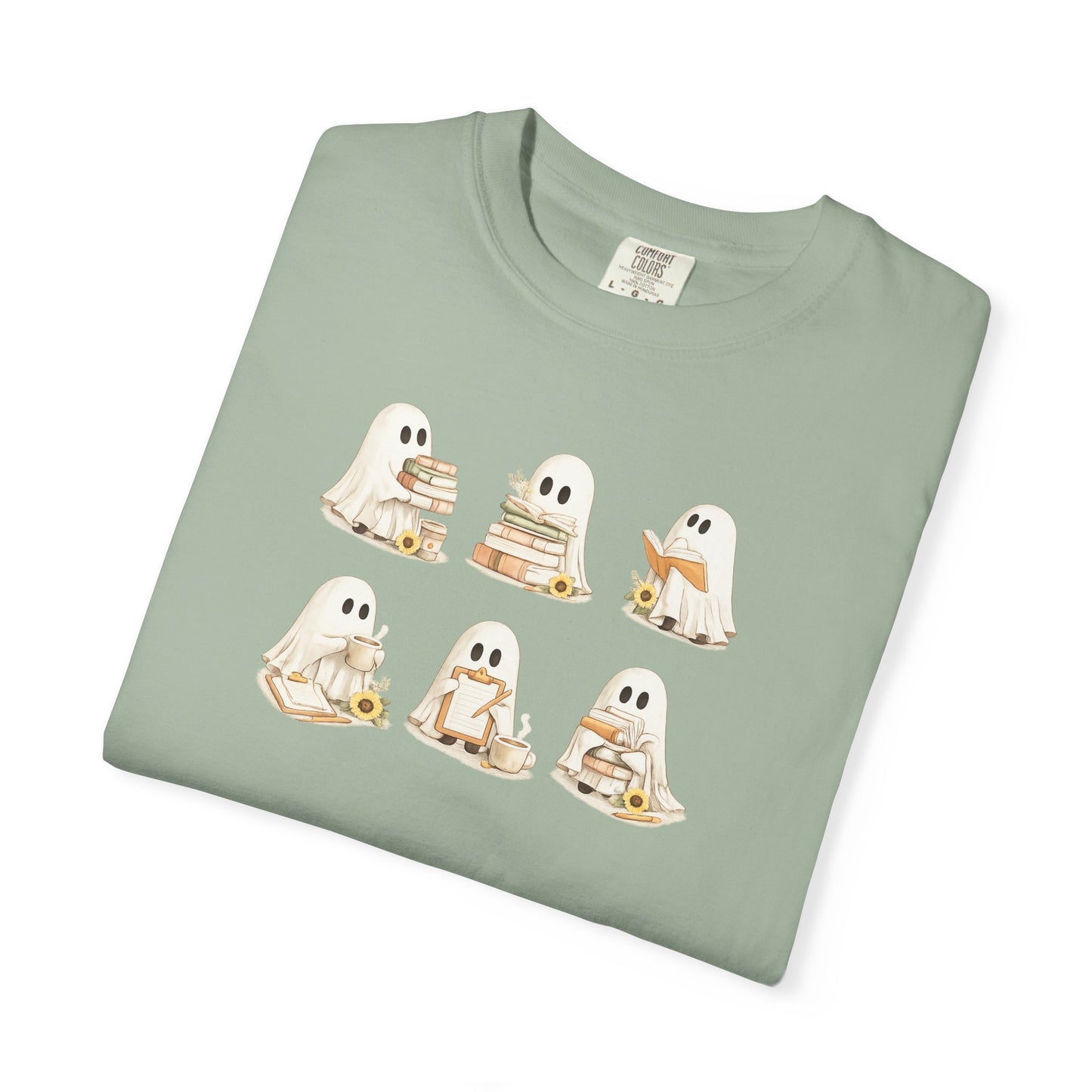 Sage green Comfort Colors t-shirt folded flat lay with six hand-illustrated ghosts holding books design - Ghost Teacher Shirt by The Teechers Thread