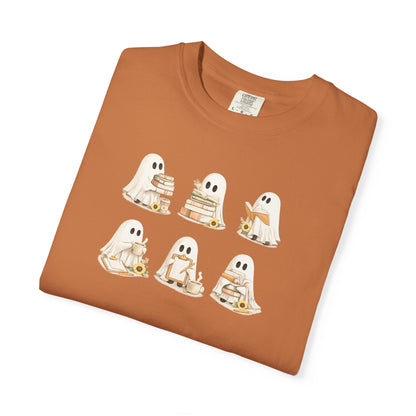 Rust orange Comfort Colors t-shirt folded flat lay with six hand-illustrated ghosts holding books design - Ghost Teacher Shirt by The Teechers Thread