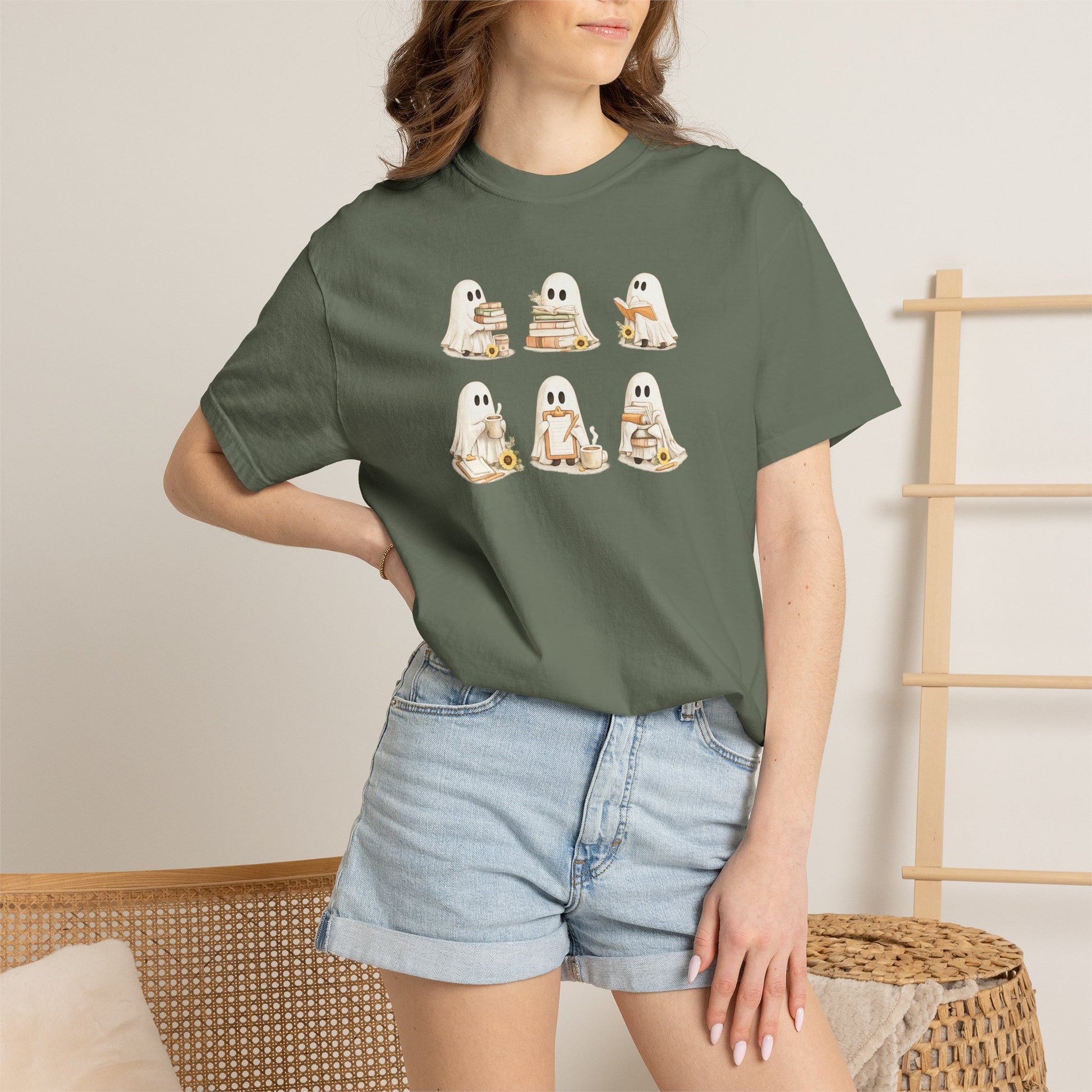 Woman wearing forest green Comfort Colors Ghost Teacher Shirt with hand-illustrated ghosts holding books design - The Teechers Thread
